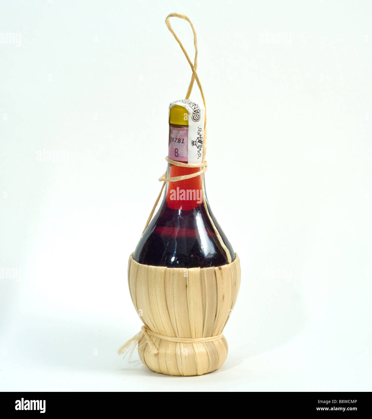 a classic italian chianti red wine bottle on a white cut out background