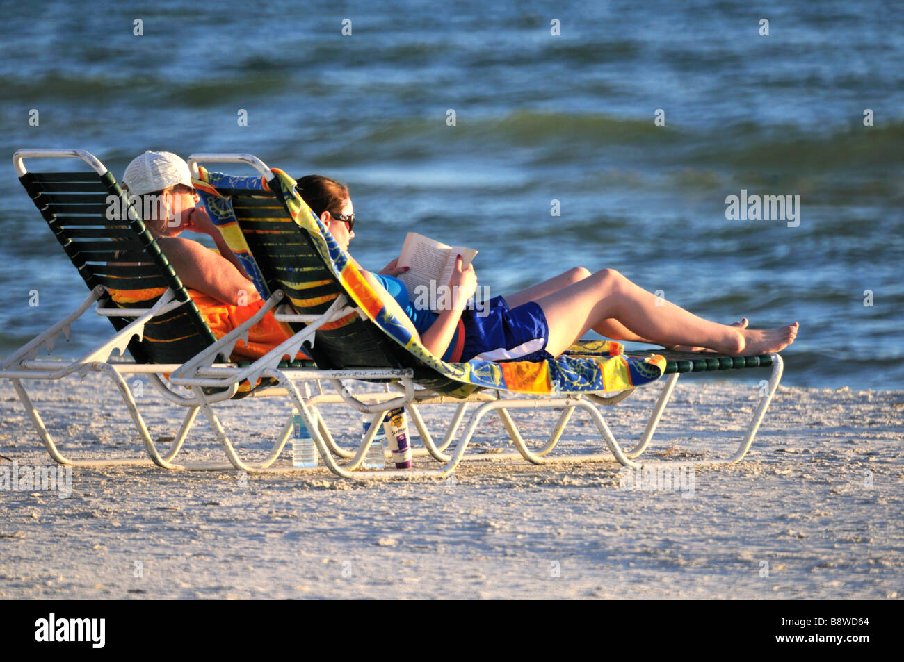 Couple relaxing on the beach Stock Photo - Alamy