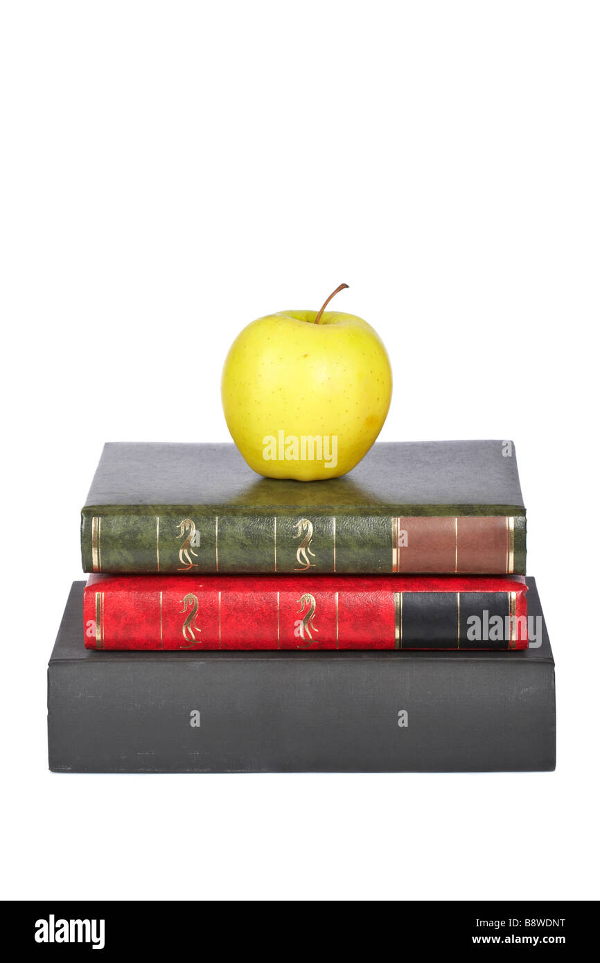 Yellow apple on old books isolated on white background Stock Photo - Alamy