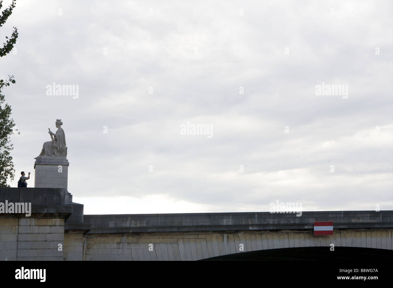 A tourist photographs a statue on the Ponts du Carrousel Paris France Friday July 20 2007 Stock Photo
