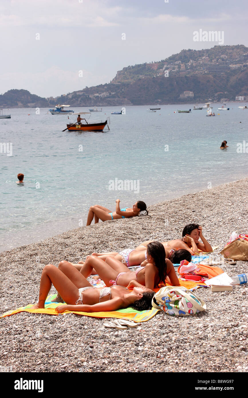 Sunbathers on a beach in Letojanni Sicily Italy Stock Photo