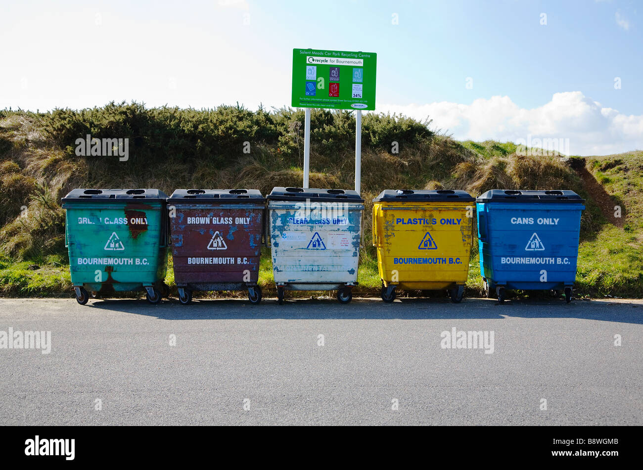 Bournemouth Council, Solent Meads Recycling Centre. Bournemouth, Dorset. UK. Row of five bins for glass, plastic and cans. Stock Photo
