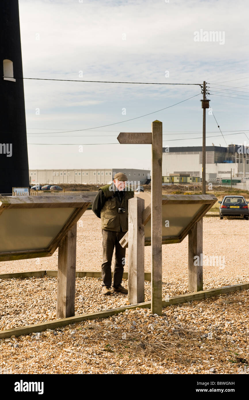 Man reading the notice board outside the narrow gauge railway cafe at Dungeness Stock Photo