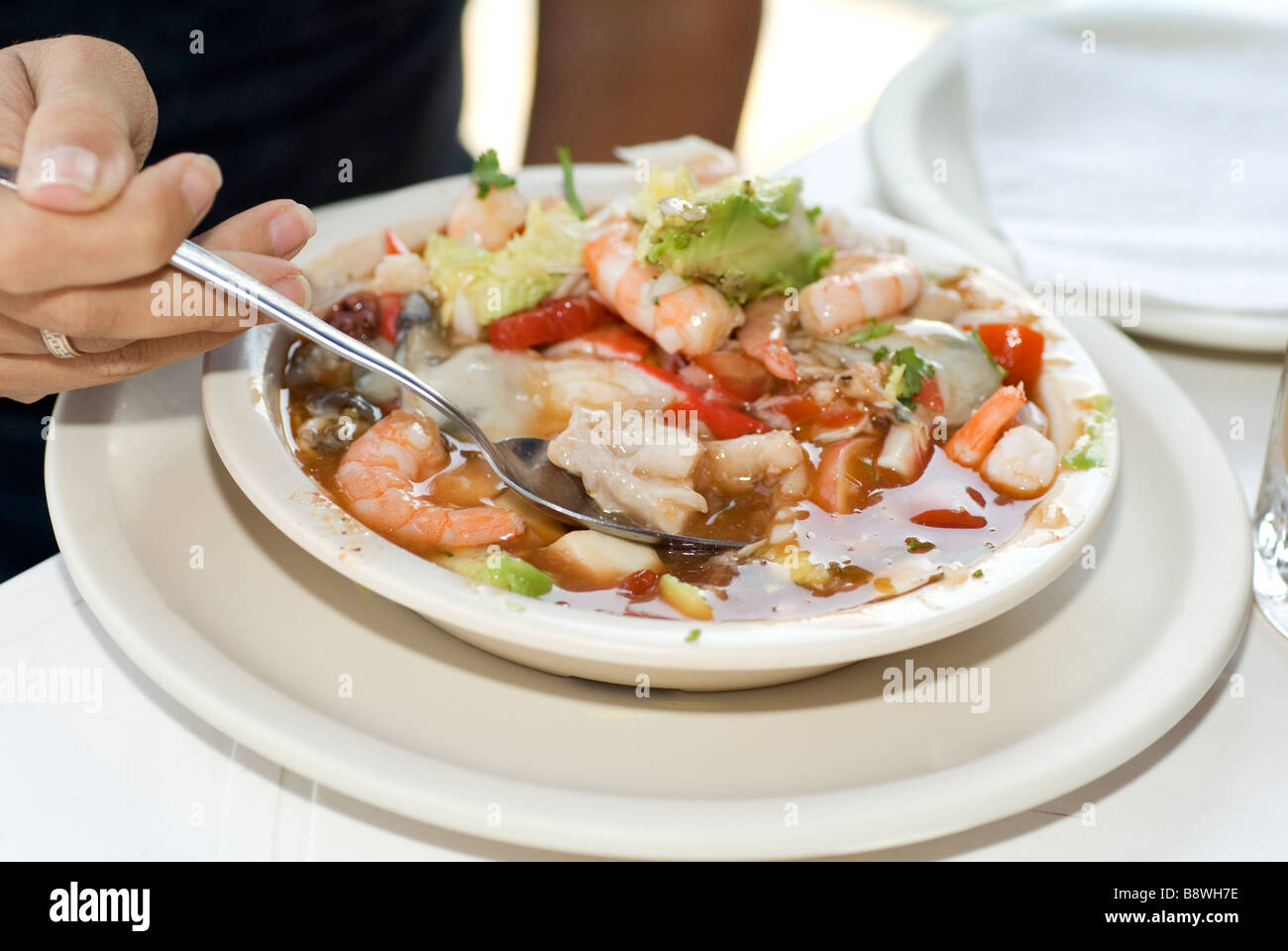 a tourist eating soup with seafood Stock Photo