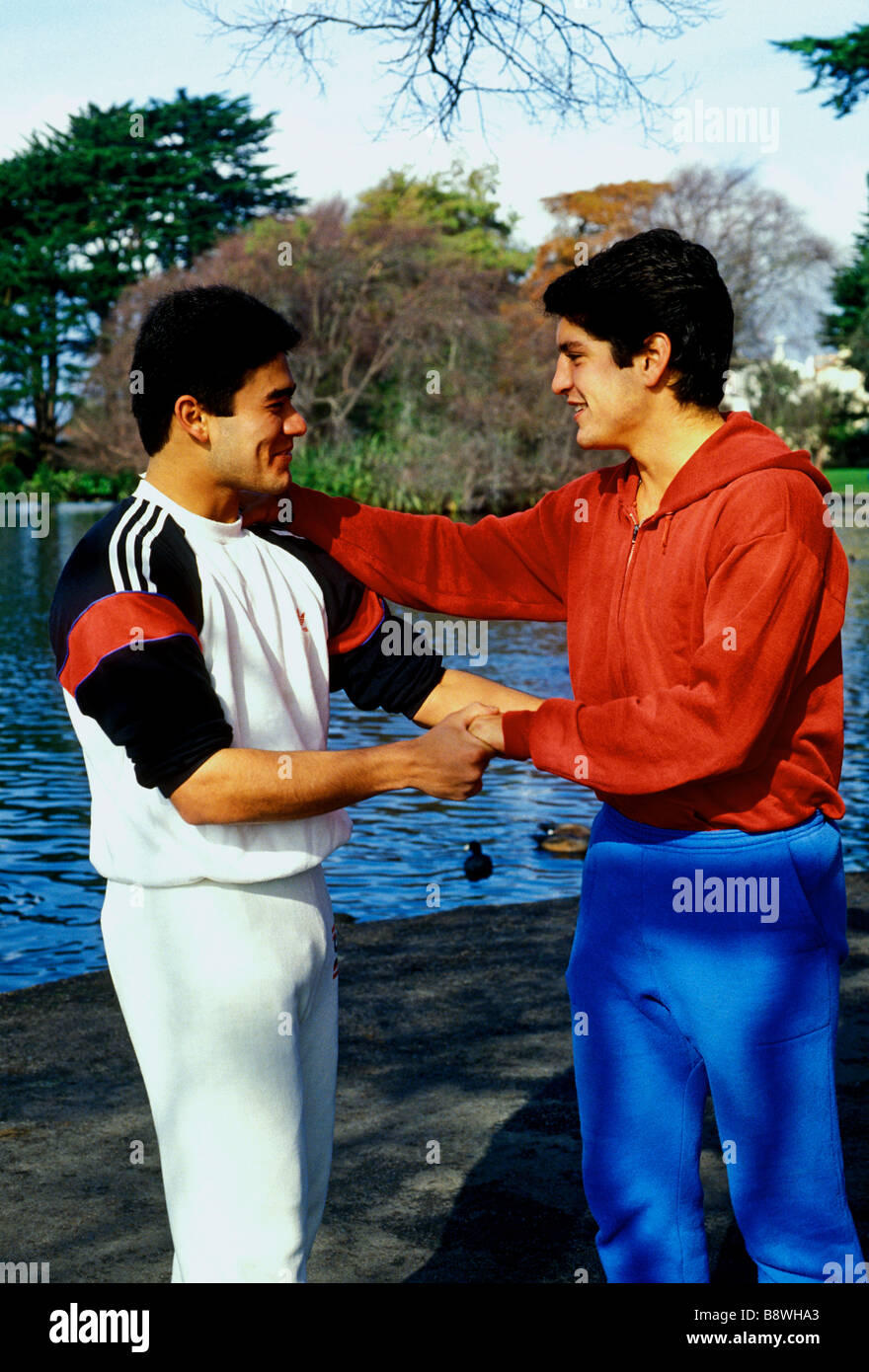 Mexican-American, Salvadorian-American, teens, teen boys, teenage boys, teenagers, good friends, greeting, shaking hands, San Francisco, California Stock Photo