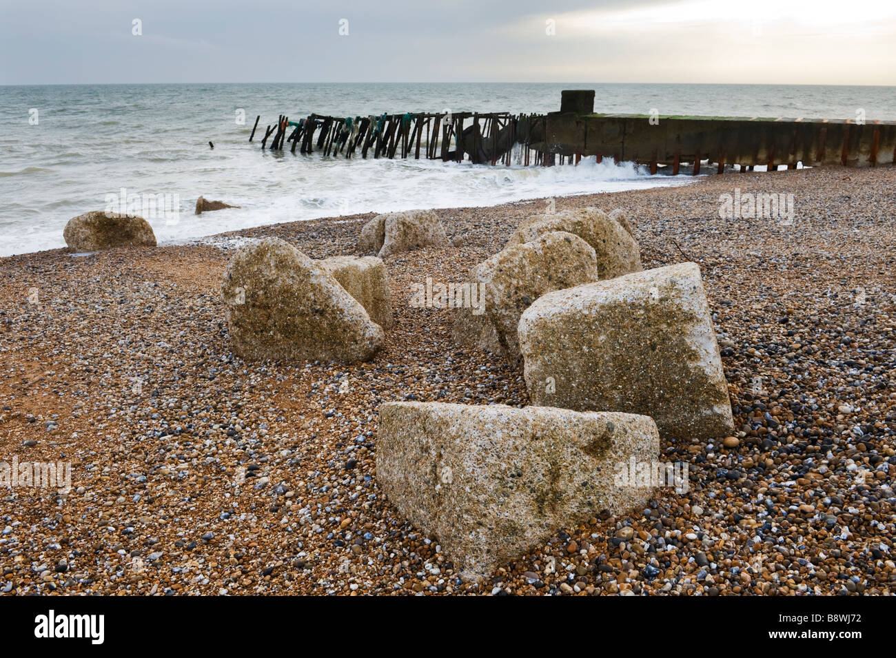 Concrete blocks and an old jetty on Dengemarsh shingle beach at
