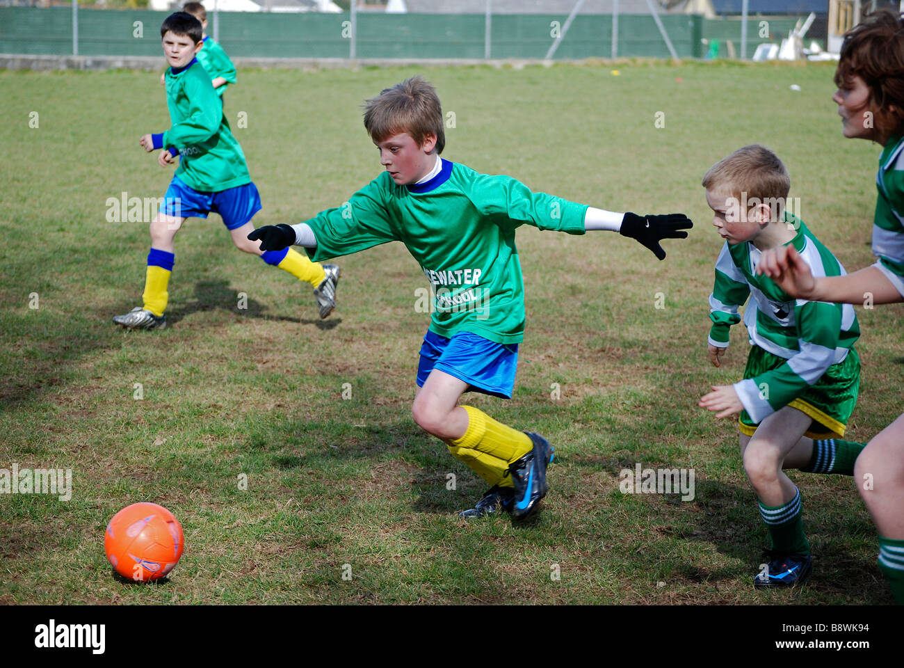 young boys playing football, uk Stock Photo