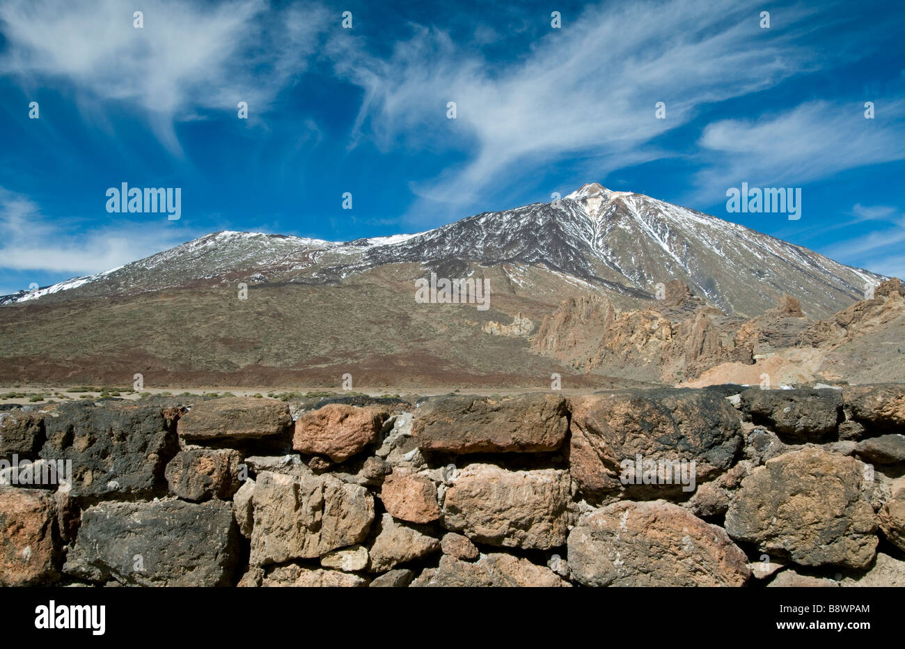 Mount Teide in Teide National Park with rustic typical wall built with abundant volcanic stone Tenerife Canary Islands Spain Stock Photo