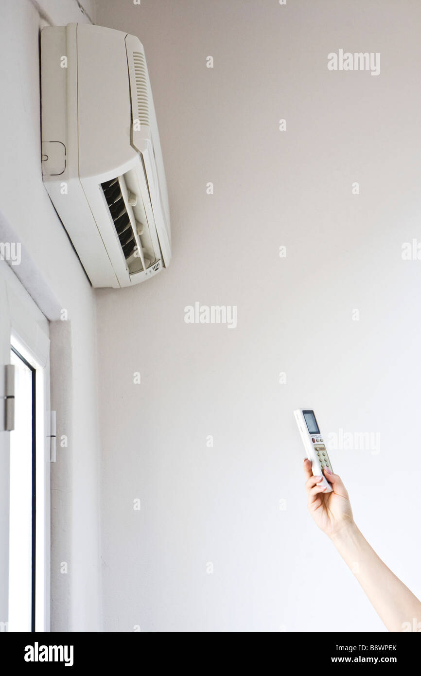 woman turn on air conditioning Stock Photo Alamy