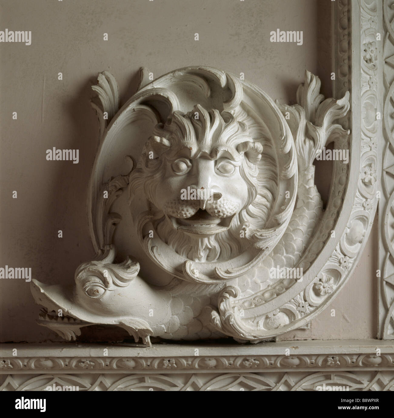 Detail of Lion s Head and Dolphin motif at the corner of the carved window surround by lightfoot in The Great Red Room Stock Photo