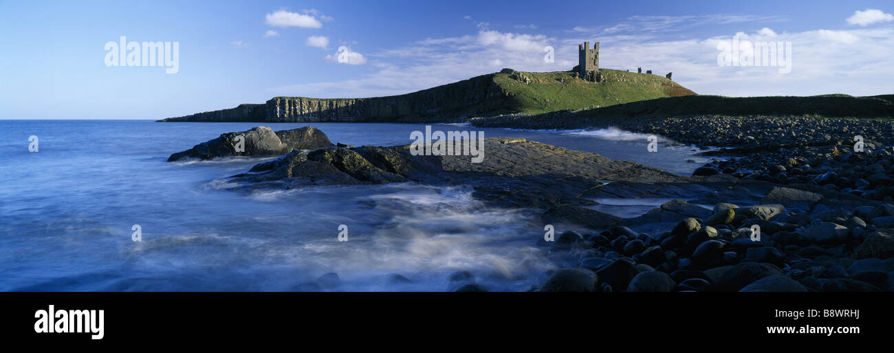 The ruins of Dunstanburgh Castle standing out against the sky seen from ...