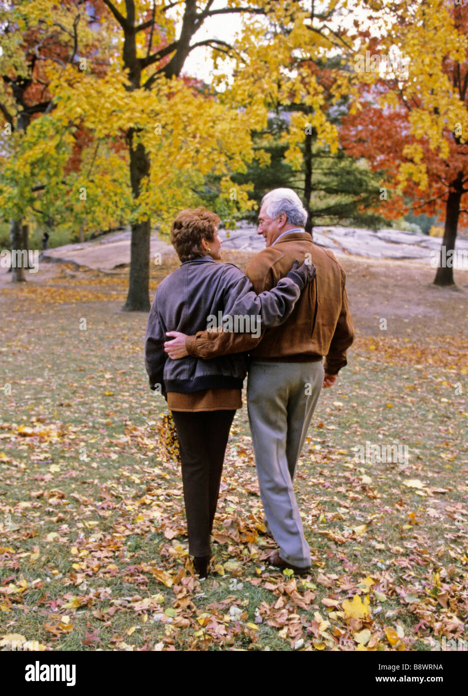 Mature couple in a park fall Stock Photo - Alamy