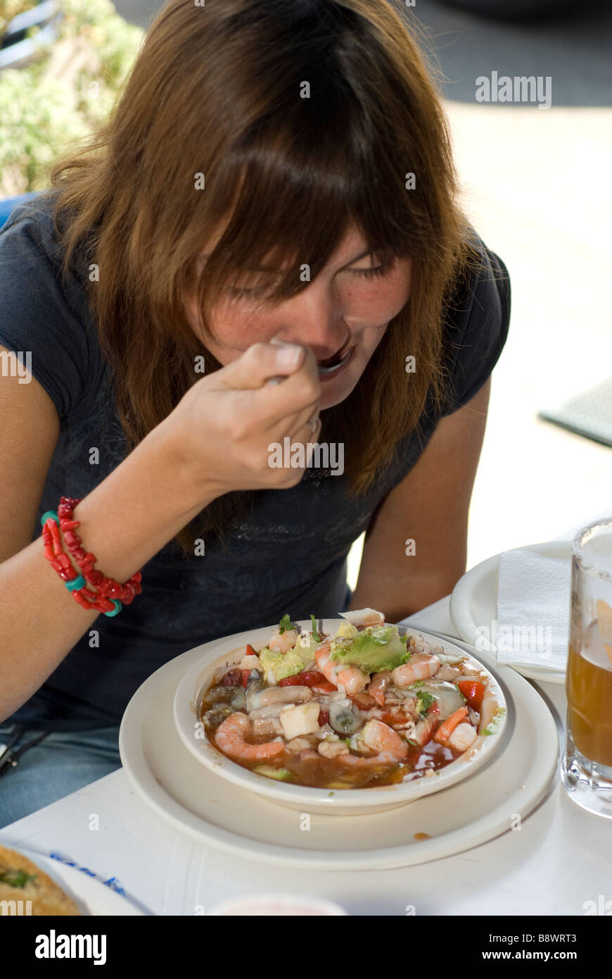 a tourist eating soup with seafood in Mexico Stock Photo