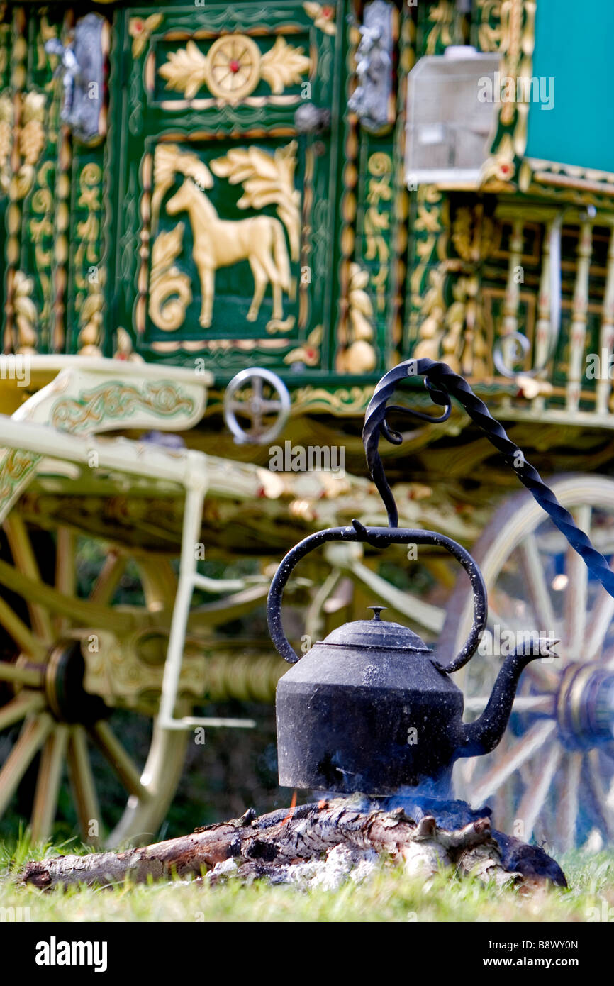 Gypsy caravan camp fire with water kettle over fire. Stow-on-the-Wold, Cotswolds, Gloucestershire, England Stock Photo