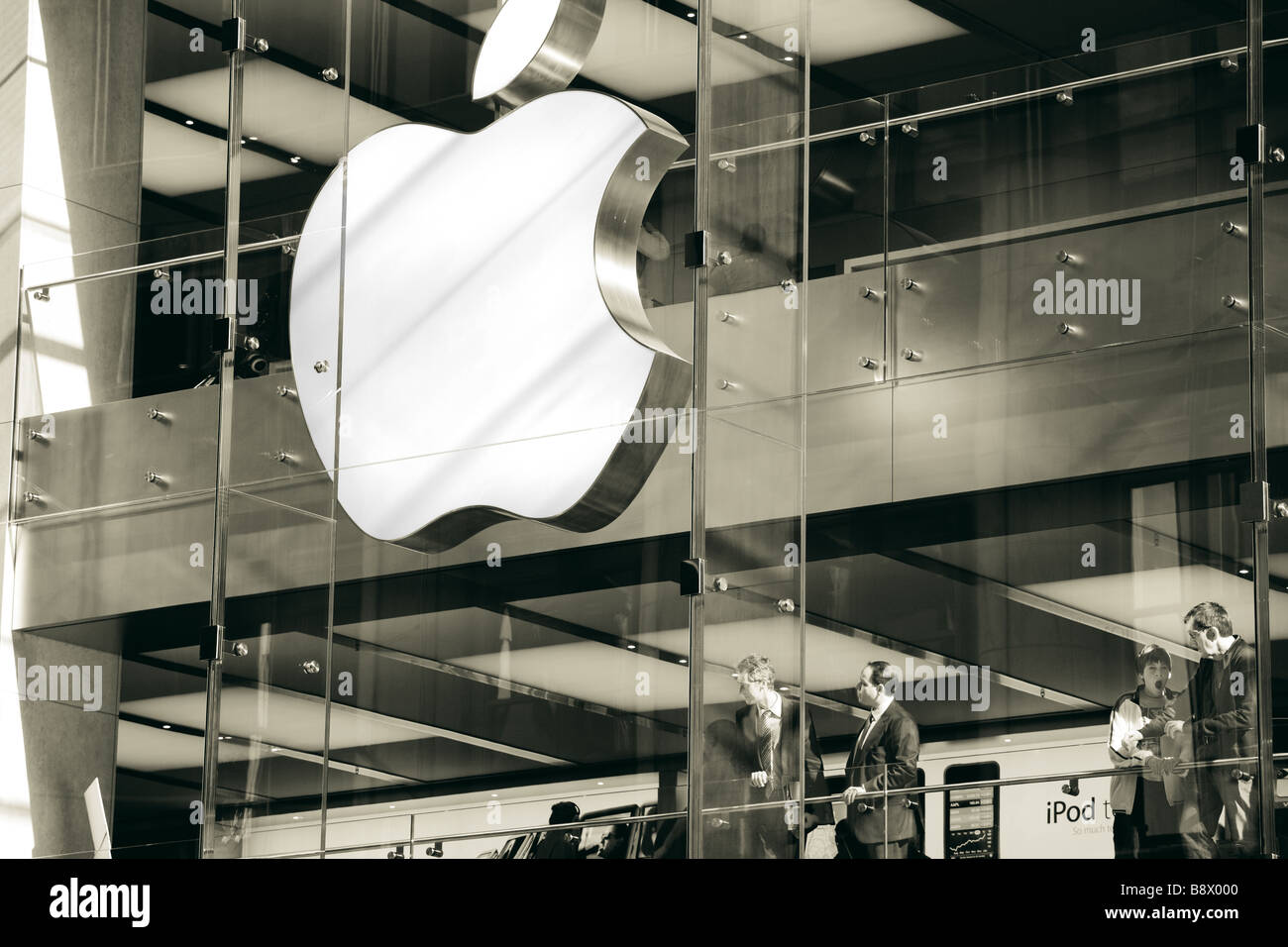 Business people and families are both shopping at the Sydney Apple Store. Sydney NSW Australia. Black and white. Stock Photo
