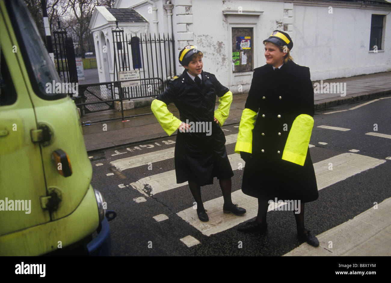 Traffic Wardens pedestrian crossing duty central London UK. Having a bit of fun with the lorry driver. 1985 1980s England HOMER SYKES Stock Photo