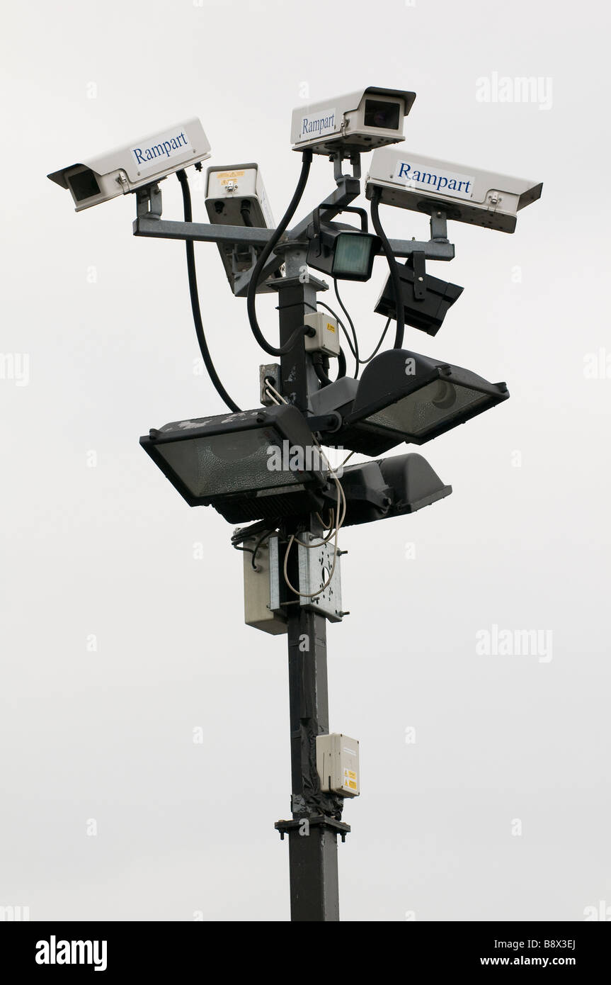 A cluster of CCTV cameras and floodlights mounted on a post in a car park in Worcestershire England UK Stock Photo