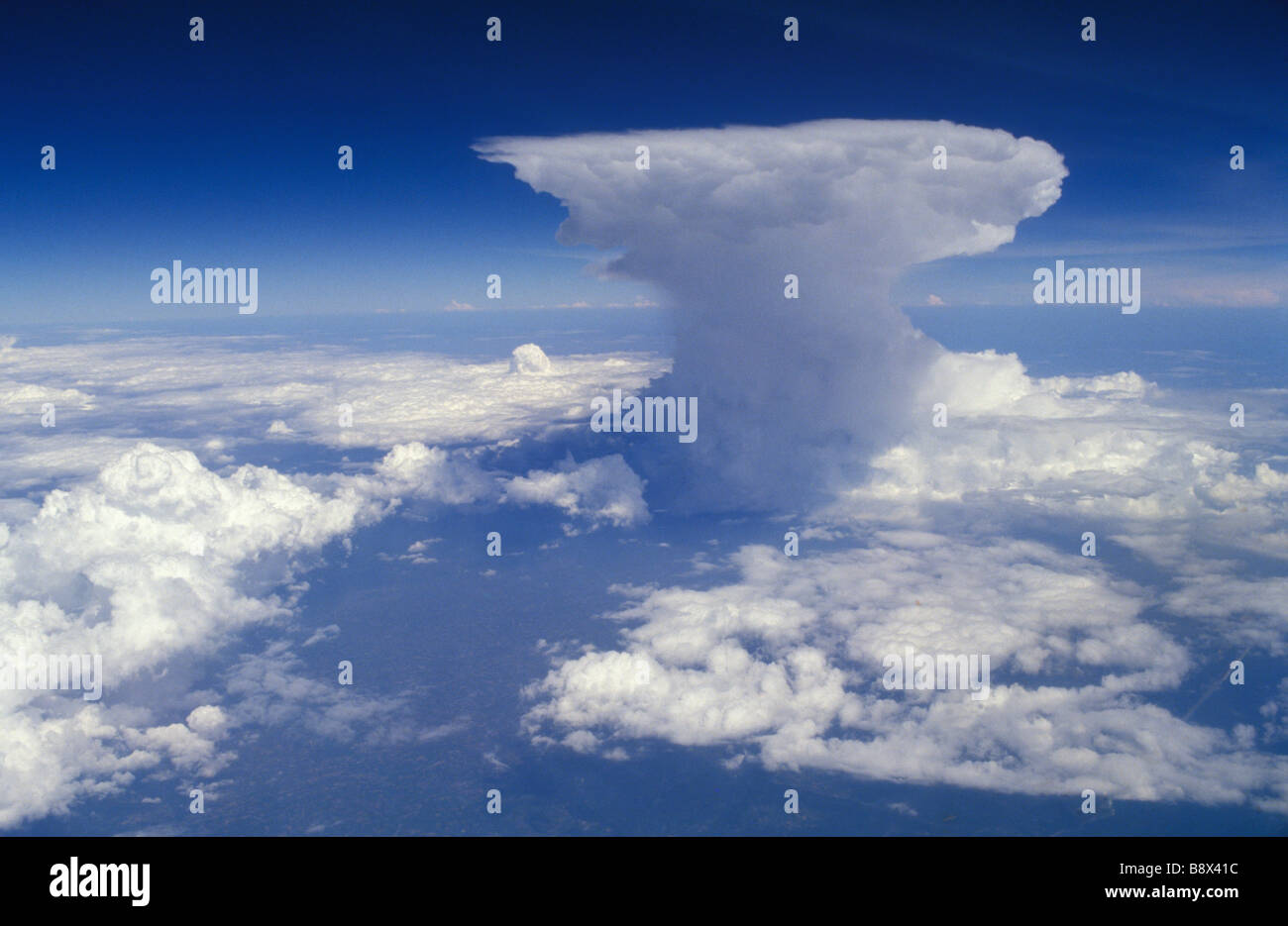 Cumulonimbus Incus Anvilheads flat topped Cumulus Nimbus cloud from airplane cockpit window HOMER SYKES Stock Photo