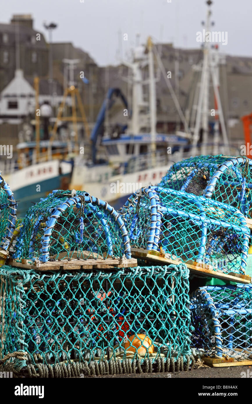 Lobster and crab pots line the shore at Peterhead Harbour, Scotland, UK, the largest whitefish port in the UK Stock Photo