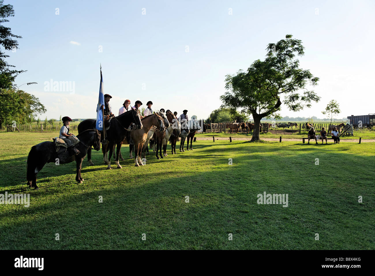 Group of gauchos lined up with the Argentina Flag - Argentina Stock Photo