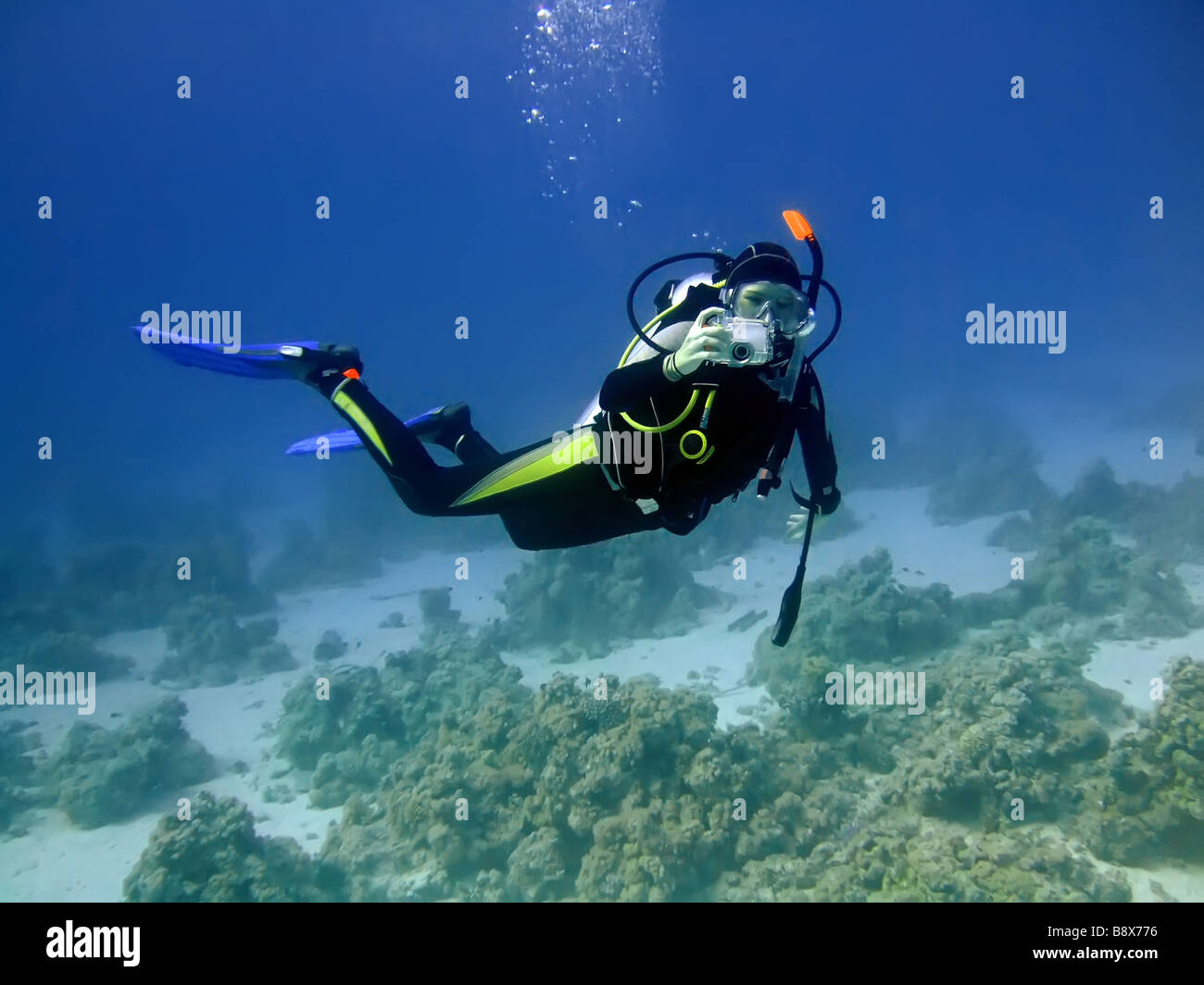 Diver with camera in deep and bubbles Underwater photographer Stock Photo