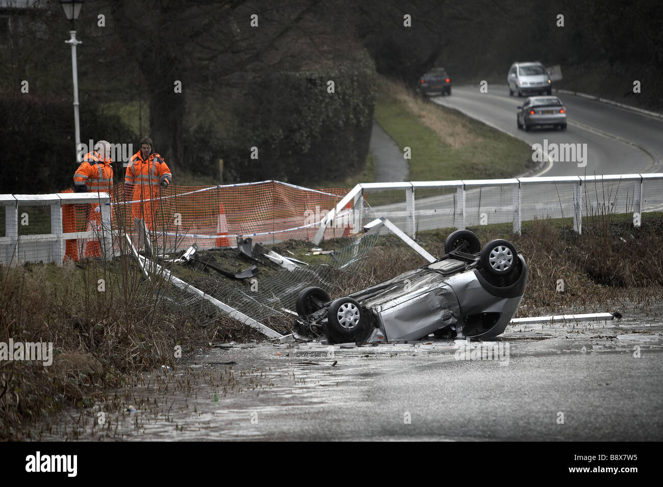 car crashed and overturned in frozen pond UK Stock Photo