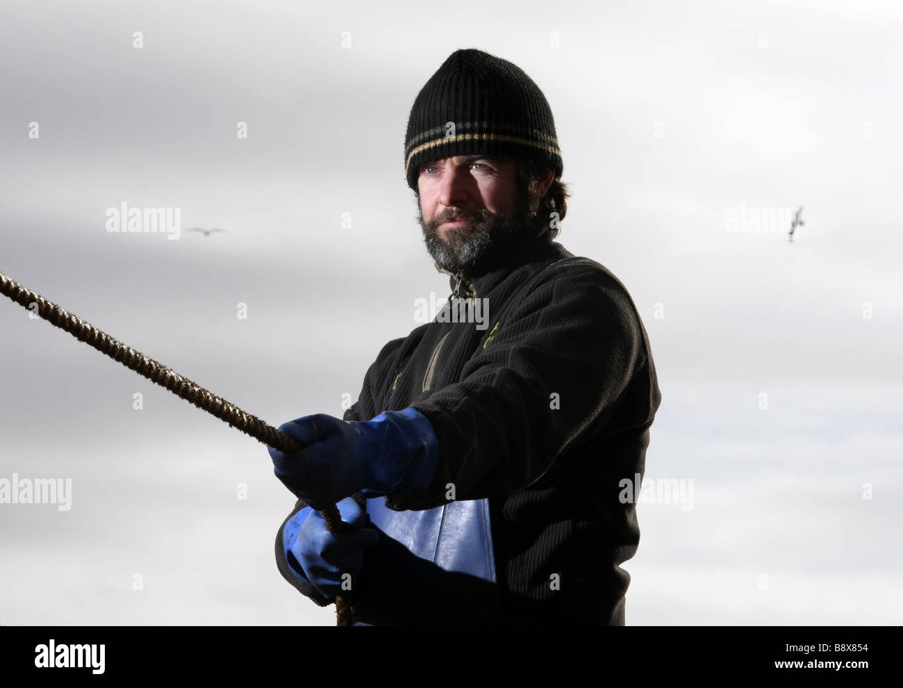 North sea fisherman based in Peterhead, Scotland, working on a fishing boat Stock Photo