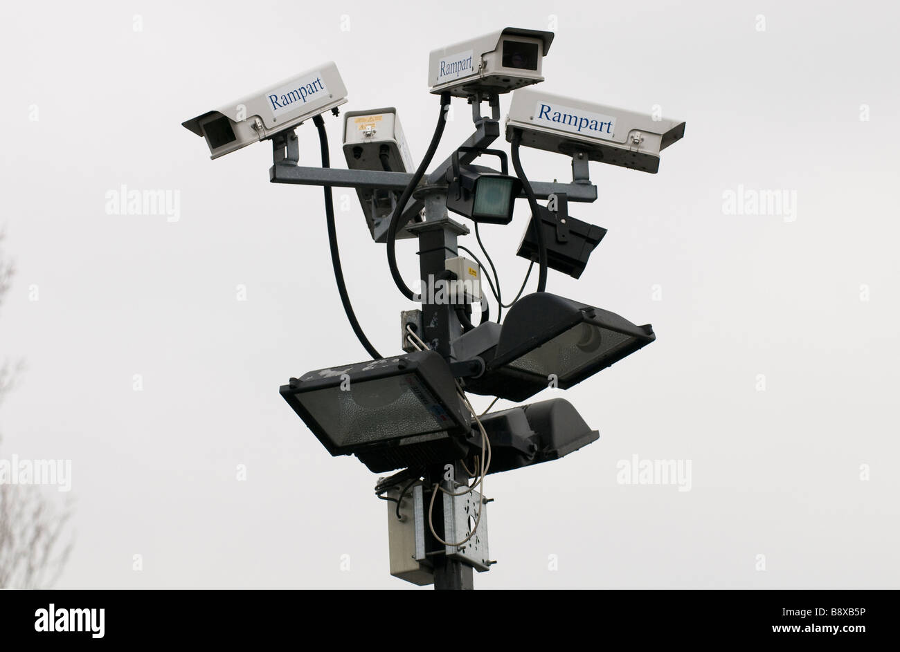 A cluster of CCTV cameras and floodlights mounted on a post in a car park in Worcestershire England UK Stock Photo