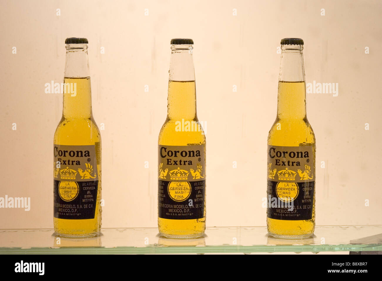three bottles of Mexican beers displayed on restaurant window case