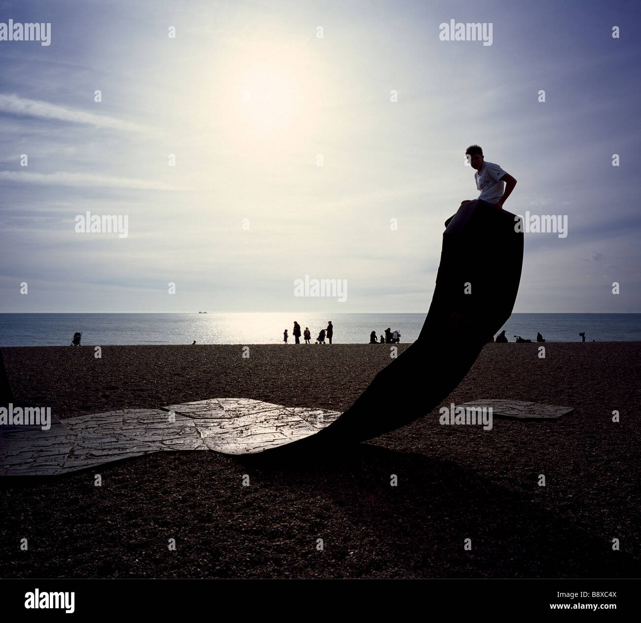 Boy on a modern art sculpture called Passacaglia. Brighton Beach, Sussex, England, UK. Stock Photo