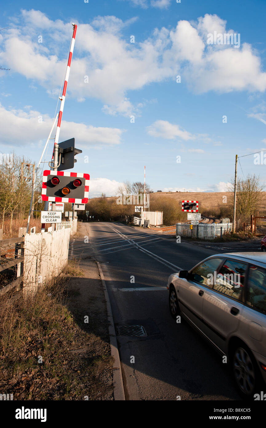 Car passing at a railway crossing at the junction of a train track and road.Kirkby In Ashfield, Nottinghamshire, England Stock Photo