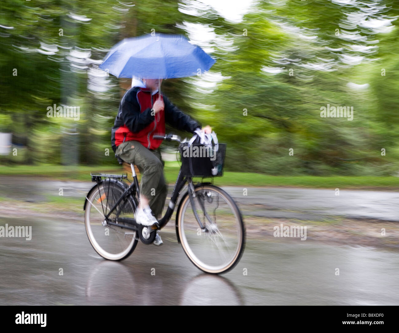 Cyclist with umbrella hires stock photography and images Alamy