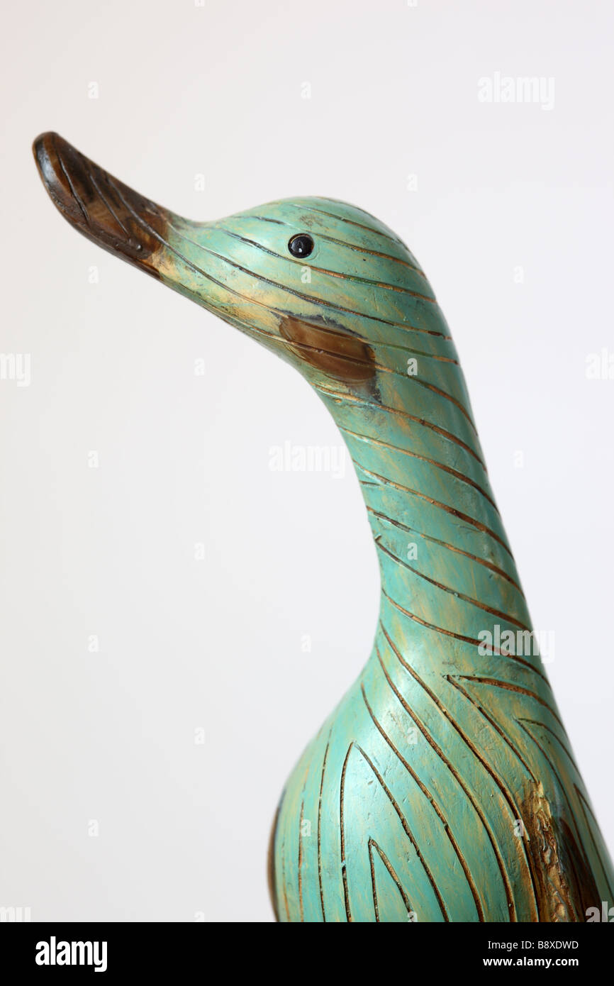 Close up of a ornamental green wooden duck against a white background Stock Photo
