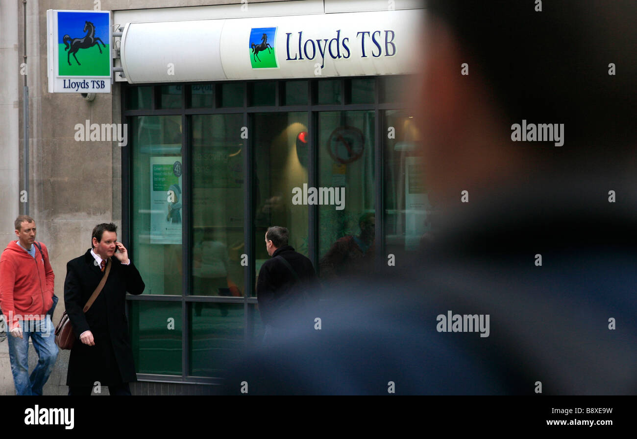 Commuters walk past a Lloyds TSB branch in central London, UK. Stock Photo