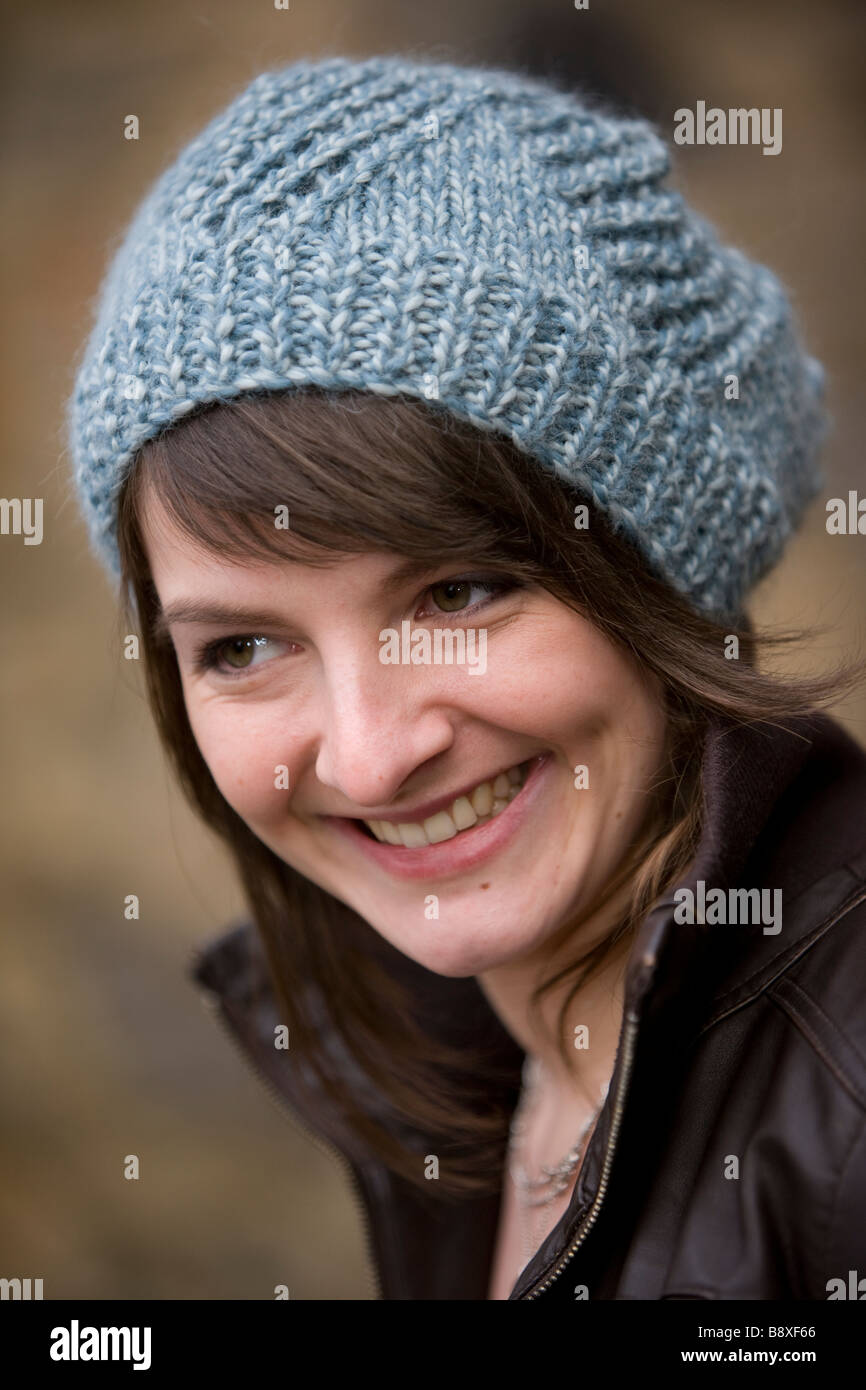 Young smiling girl wearing woolly hat and leather jacket Stock Photo ...