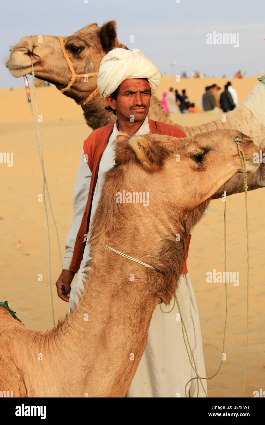 India Rajasthan Thar Desert Sam Sand Dunes man with camels Stock Photo
