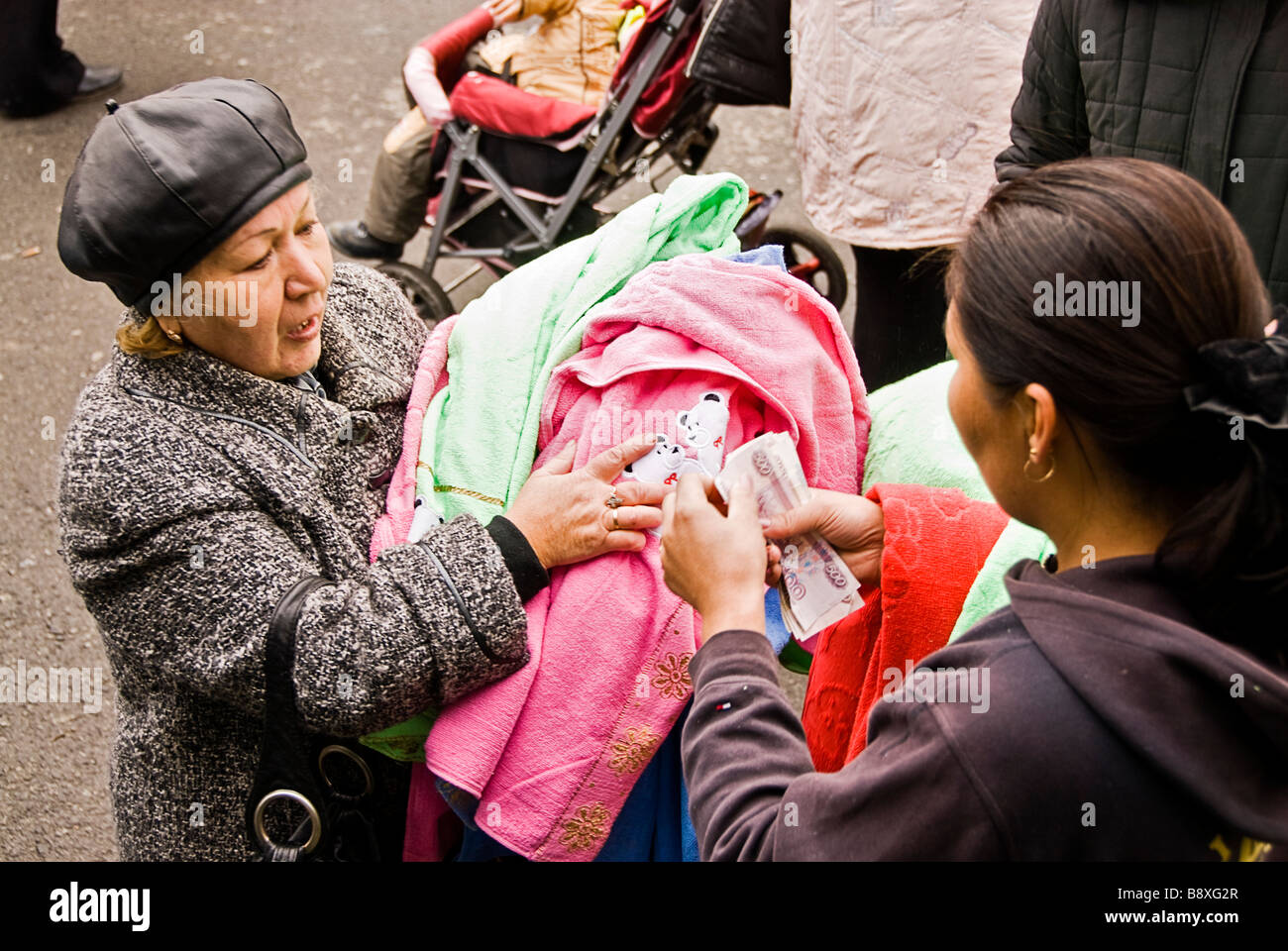 People selling and buying clothes while travelling from Mongolia to Moscow by the Transiberian train, Asia Stock Photo