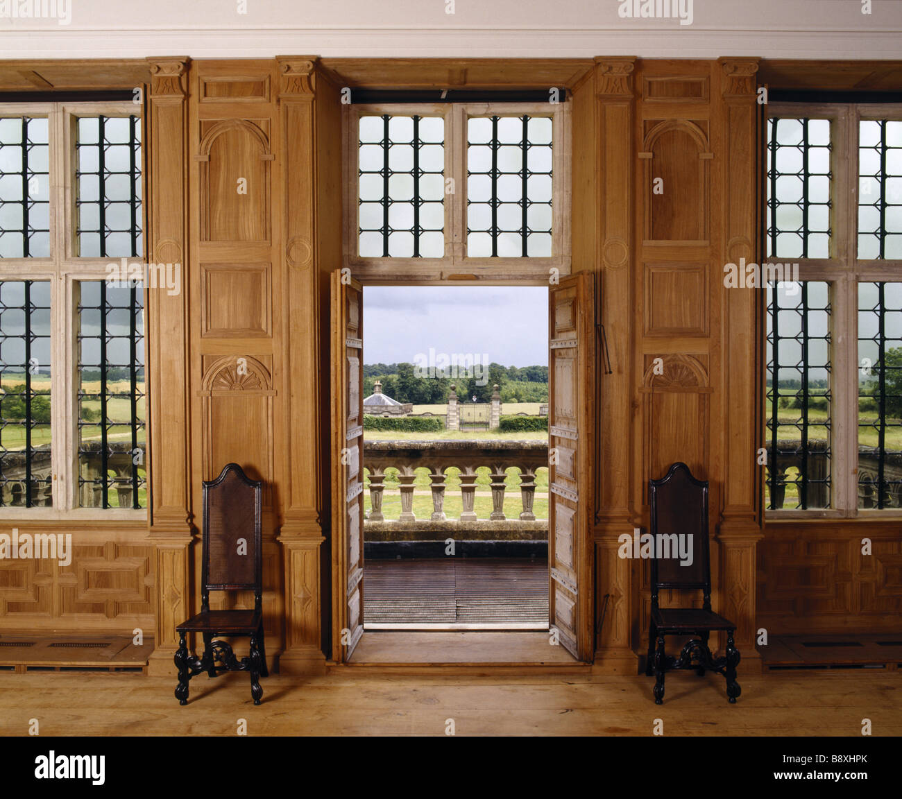 View Of The Great Room Showing Open Doors Chairs Flanking