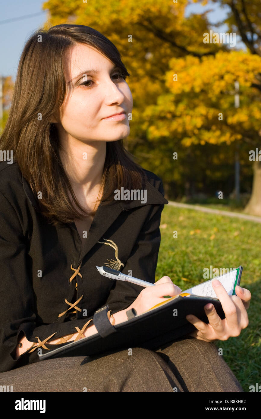 The girl writes a diary on fresh air Stock Photo Alamy