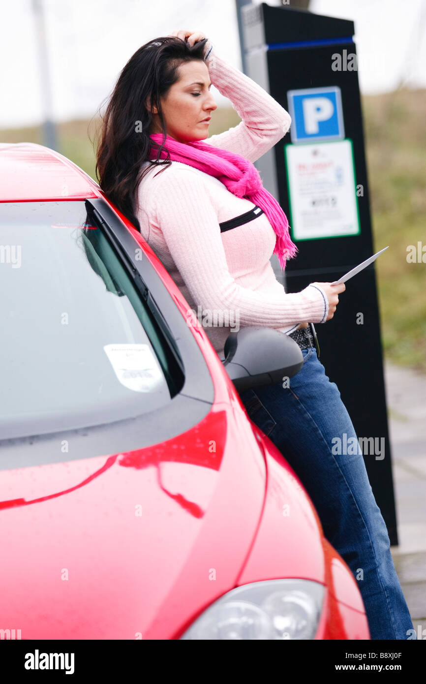 Woman with parking ticket Stock Photo