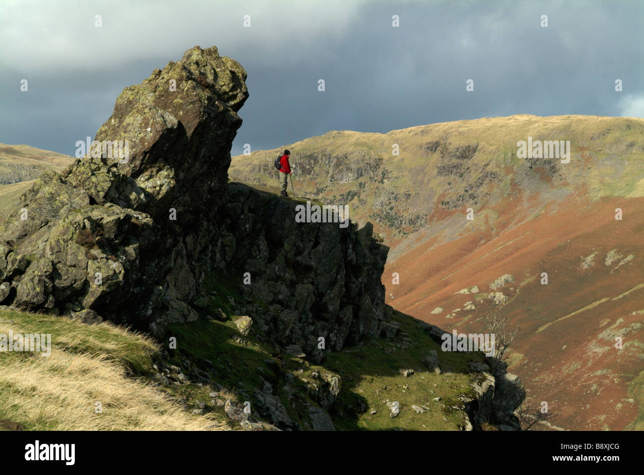 Walker stood below the Howitzer on the top of Helm Crag, Lake Stock Photo -  Alamy