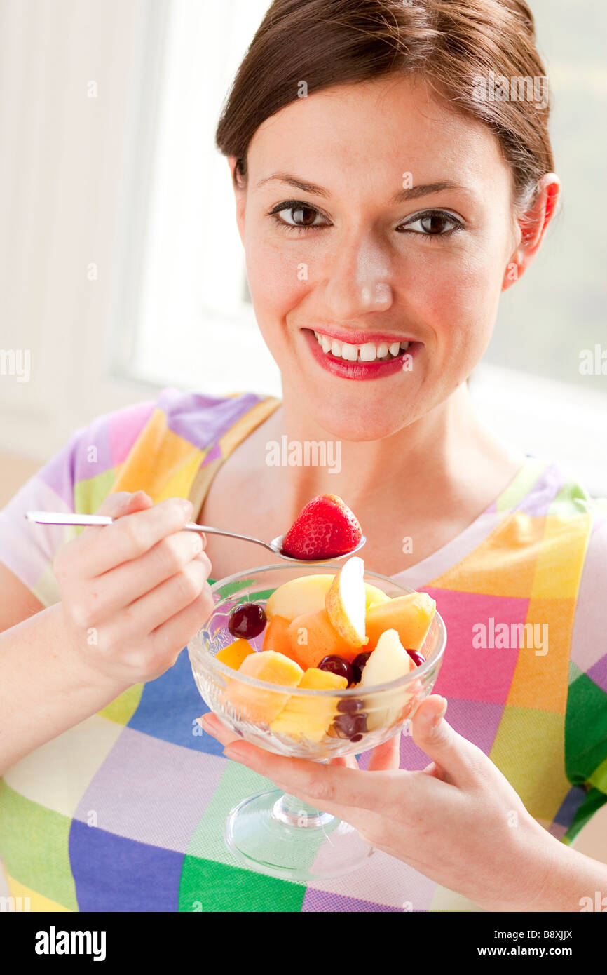 Woman eating fruit salad Stock Photo Alamy