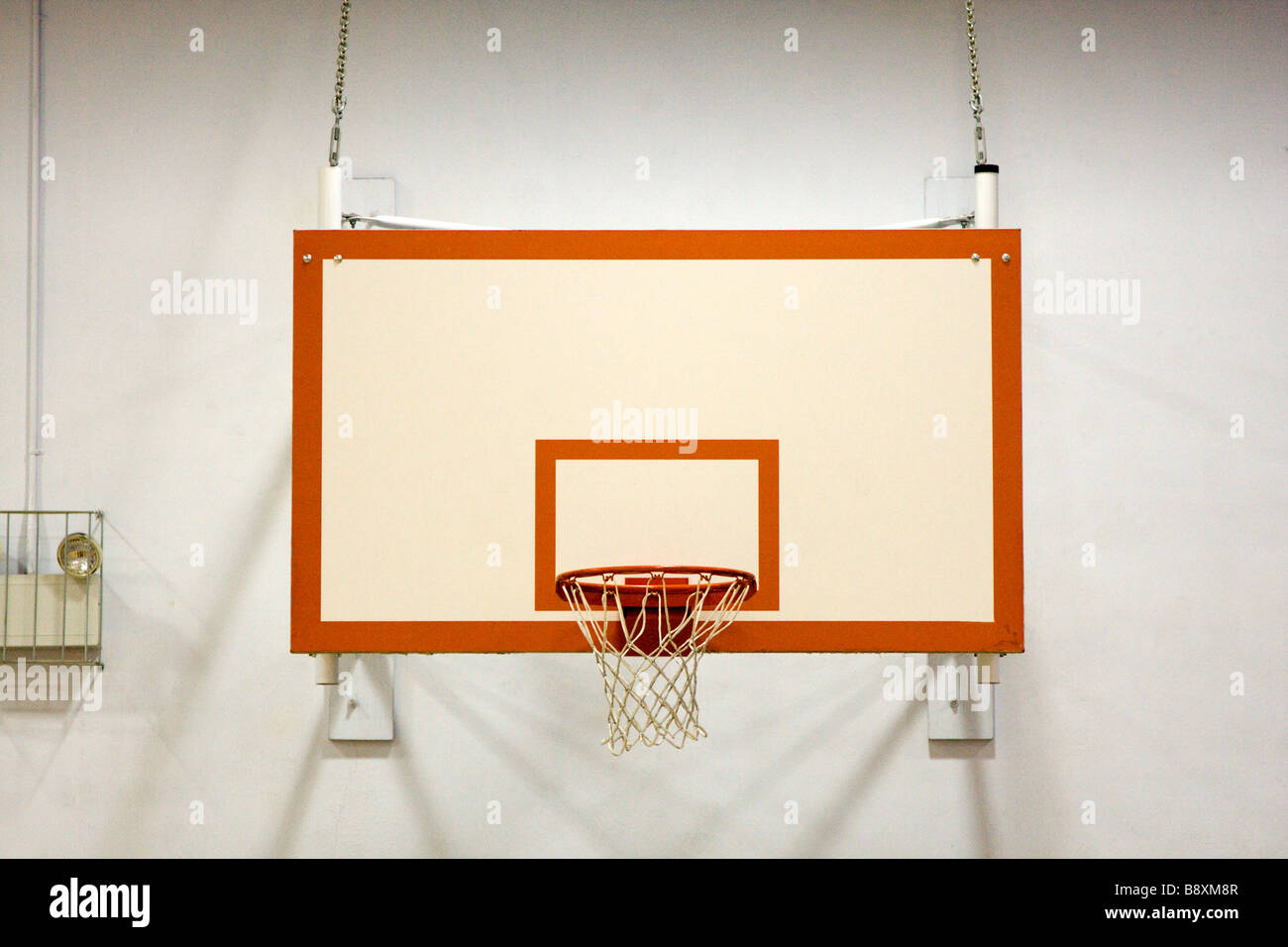Indoor Basketball Hoop in School Gymnasium Stock Photo