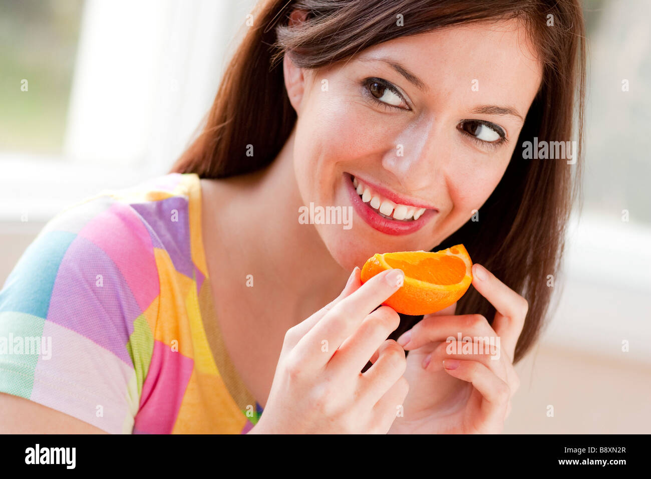 Woman eating a Orange segment Stock Photo