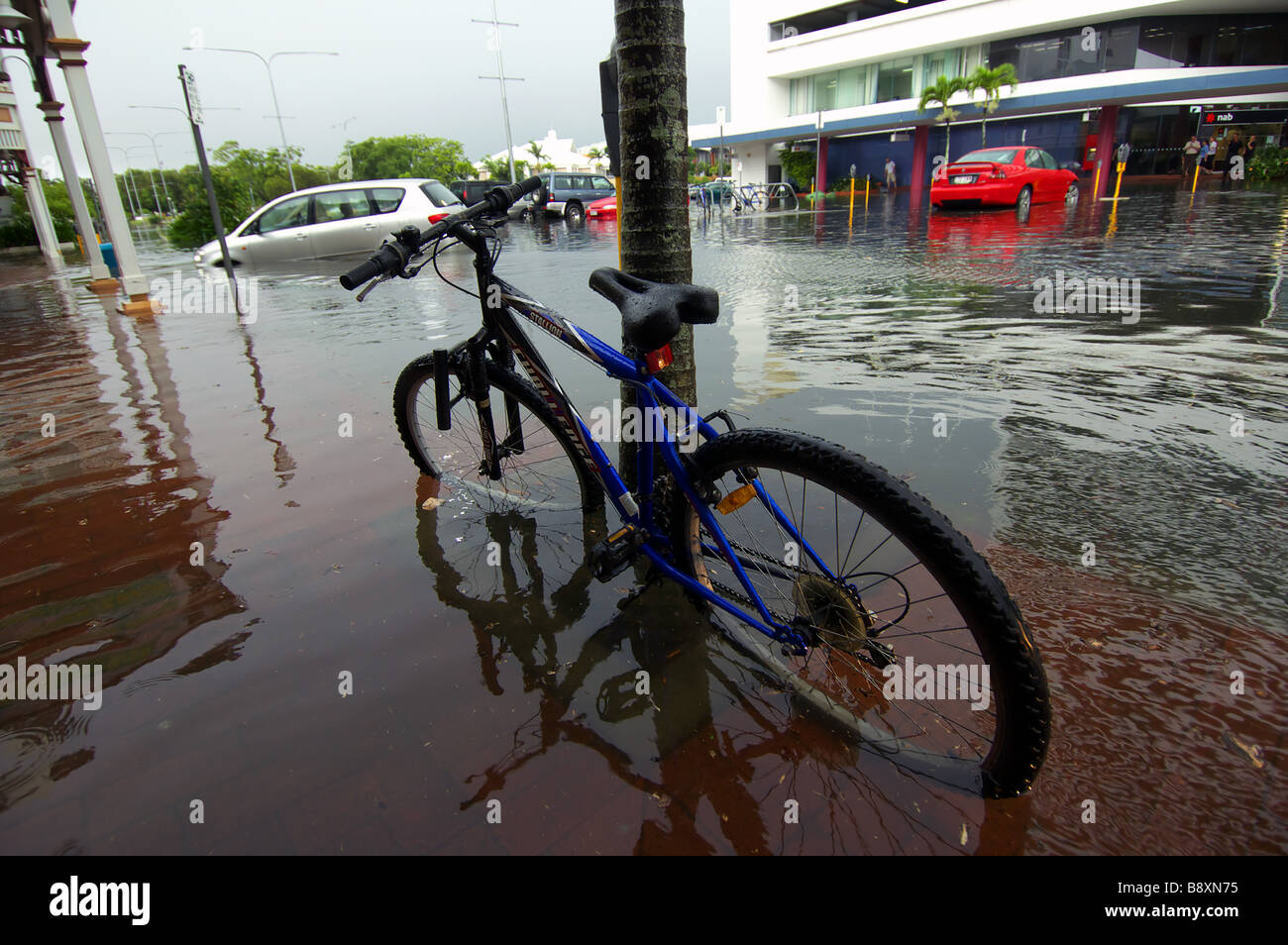 Flash flooding in catches bicycles and cars in the city streets Cairns Queensland Australia Stock Photo