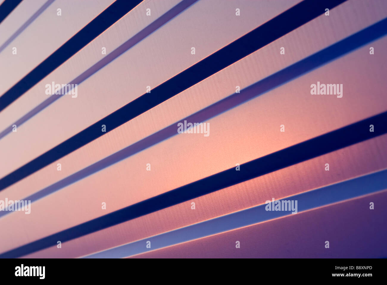 Waved blue metal sheet pattern on sunset. Stock Photo