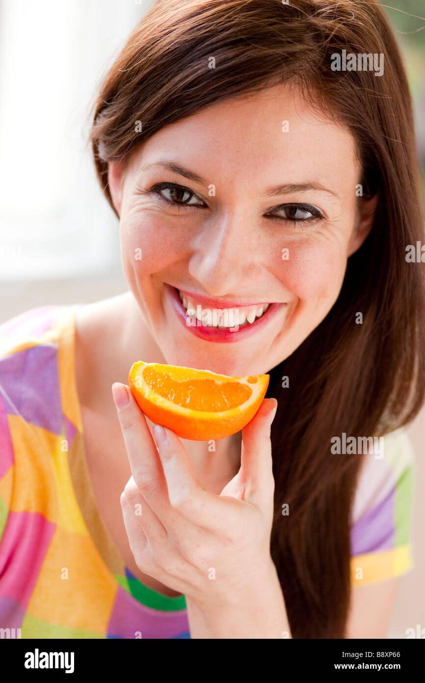 Woman eating a Orange segment Stock Photo