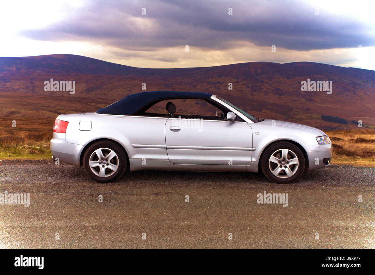 Silver Audi A4 1.8T Convertible roof coming down Stock Photo