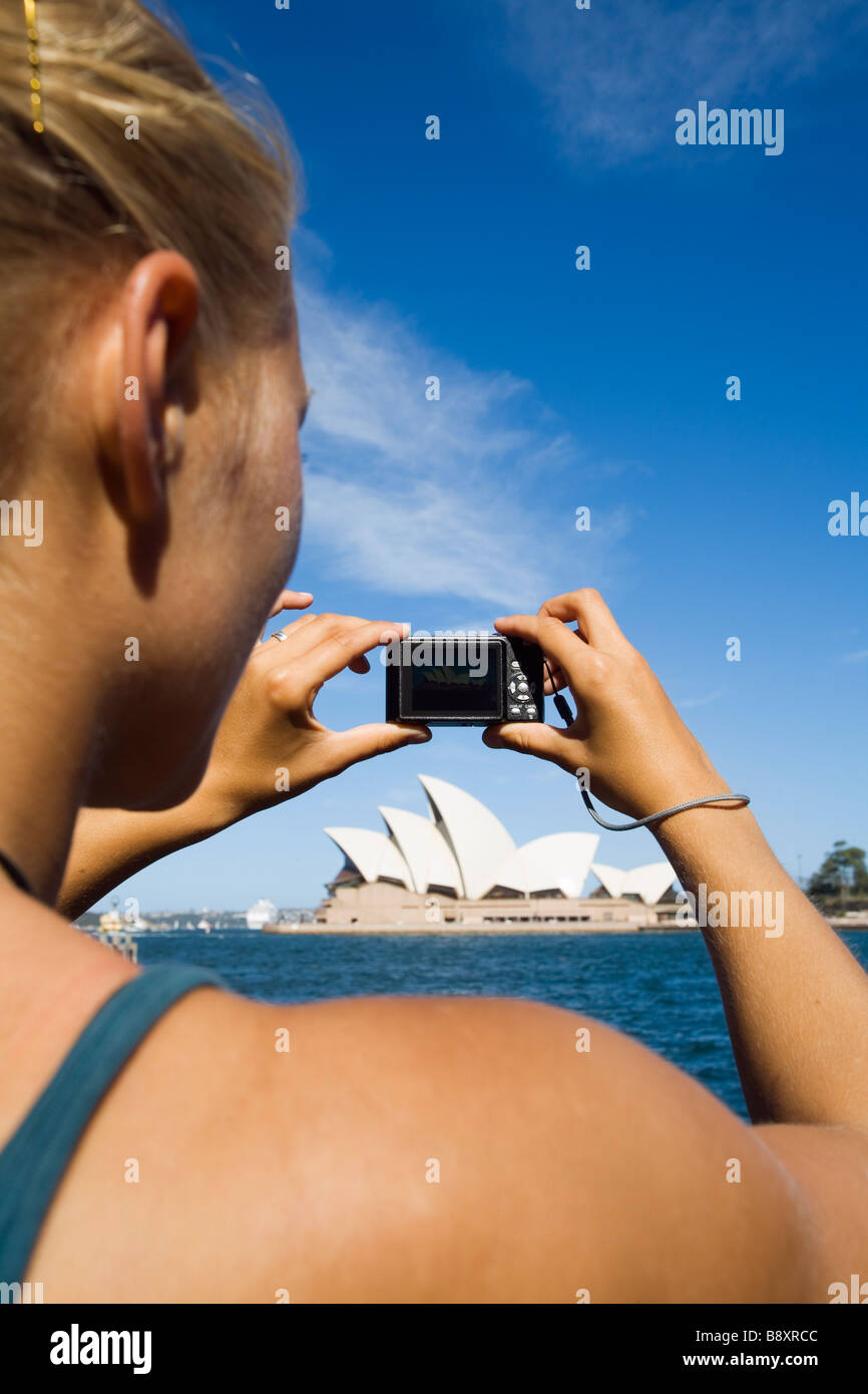 A woman photographs the Sydney Opera House.  Sydney, New South Wales, AUSTRALIA Stock Photo
