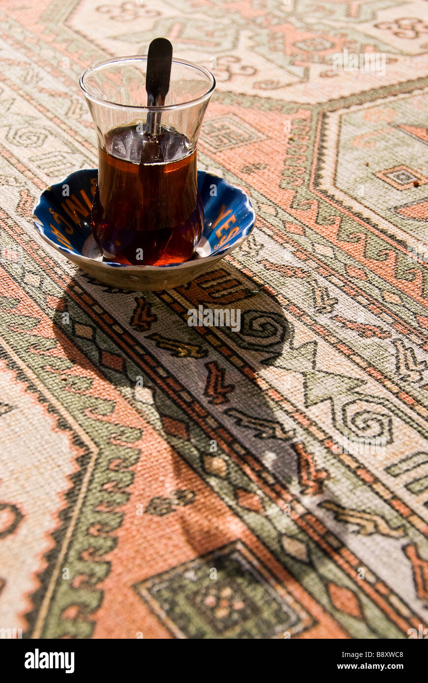 Glass of tea on a carpet, Turkey, Asia Stock Photo